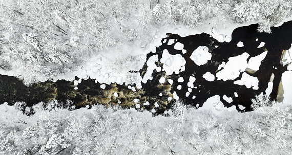 Aerial View of Boreal Nature Forest and River in Winter After Snowstorm.\nRiviere Neilson River in Zec Batiscan Neilson, Saint-Raymond, Quebec, Canada.