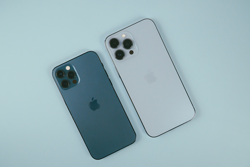 A comparison of Apple iPhone 12 Pro in Pacific Blue and Apple iPhone 13 Pro Max in Sierra Blue