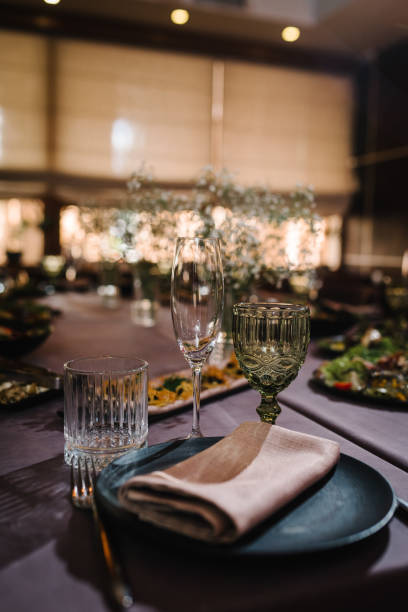 istock Closeup glasses and tableware for evening dinner party. Boho rustic banquet hall decorated served table. Birthday party, babyshower, bachelorette party, wedding, luxury style. Setting festive table. 1450626784