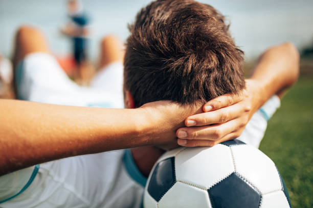 argentinian soccer player resting on the soccer ball