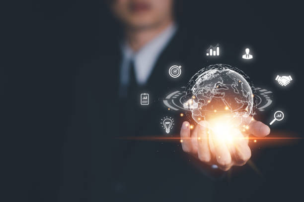 istock Hand of Businessman hold virtual global with hologram using metaverse and internet connection. Business technology link digital marketing. Application on computer. Big data and Financial banking. 1450633408