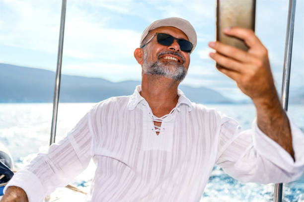 istock Mature man on a boat using the smartphone 1450636962