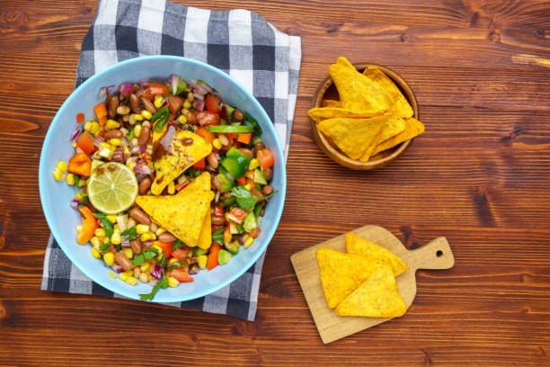 istock Salad texas caviar. Vegetable dish with corn, beans, pepper, pepper, tomatoes, beans. Served with corn chips nachos 1450642276