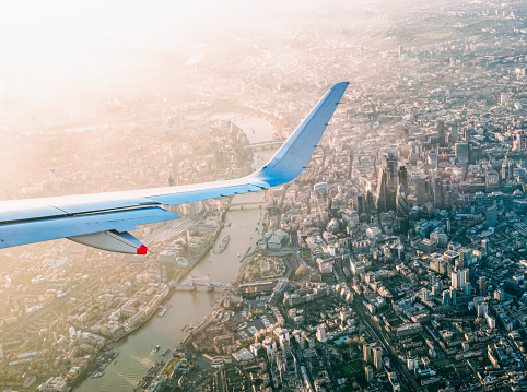 A view of central London from a commercial airliner, with the Thames, Tower Bridge and the towers of the City of London in view.