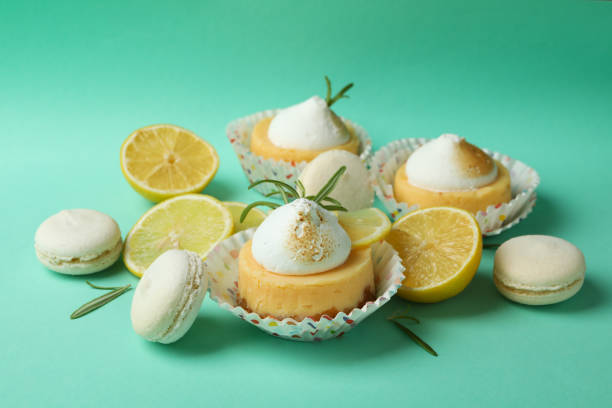 istock Lemon cupcakes, macaroons and ingredients on mint background 1450646728