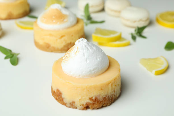 istock Lemon cupcakes, macaroons and ingredients on white background 1450648119