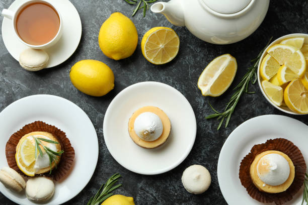 istock Concept of tasty breakfast with lemon cupcakes and macaroons 1450648375