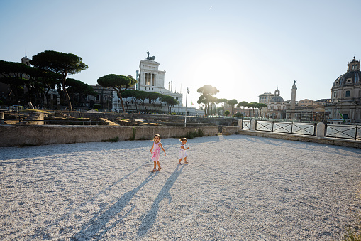 Two baby girls near Imperial Fora or Fori Imperiali in Rome, Italy.