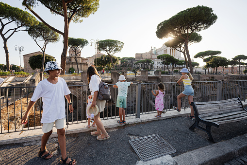 Family tourists near Forum of Augustus in Rome, Italy.