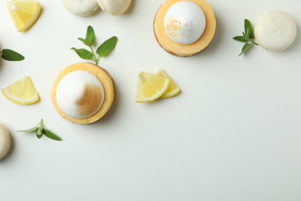 istock Lemon cupcakes, macaroons and ingredients on white background 1450648884