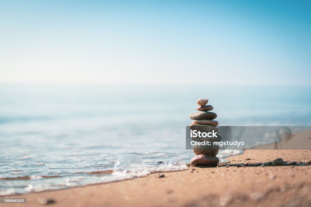 Pile of stones on the calm beach Zen-like Stock Photo