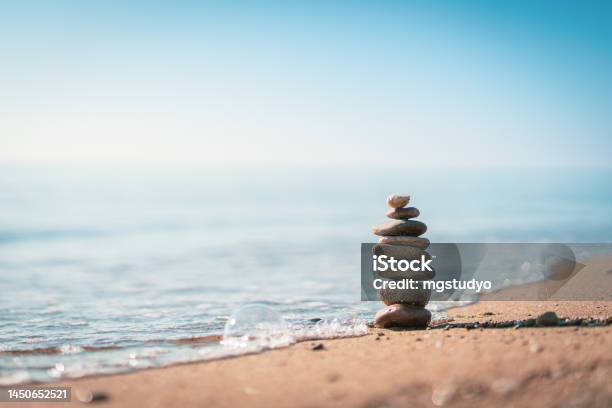 Pile Of Stones On The Calm Beach Stock Photo - Download Image Now - Zen-like, Tranquility, Sun