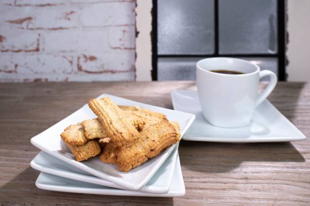 istock Closeup shot of pastry and cup of coffee on angular white porcelain tableware 1450653775