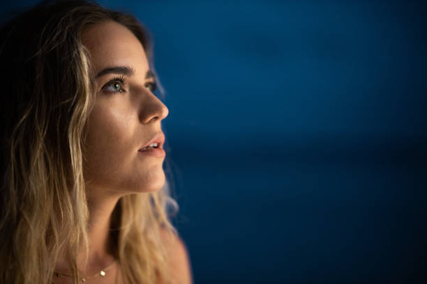 istock Young pensive woman in the night. 1450656045