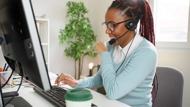 Customer support specialist talking on headset with a client