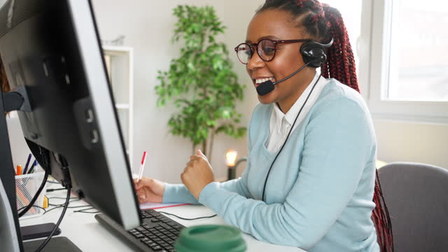 Customer support specialist talking on headset with a client