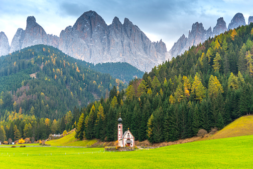 San Giovanni Church in front of Odle Group mountain peaks, Italy