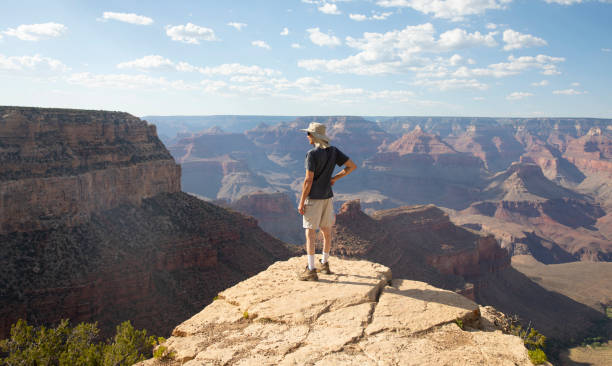 Man looking at view at Grand Canyon, South Rim. Arizona USA stock photo