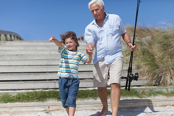 homem e o neto com postes de pesca - fishing active seniors family senior adult imagens e fotografias de stock