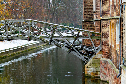 Snow on the mathematical bridge over the River Cam, Cambridge, UK.