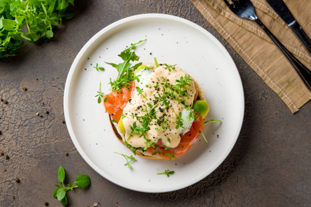 istock eggs Benedict with salmon and avocado on white plate top view 1450668300