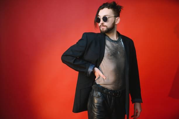 istock Young gay man is standing in the studio and posing for a camera. 1450673484