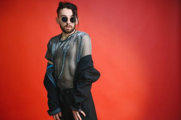 istock Young gay man is standing in the studio and posing for a camera. 1450673534
