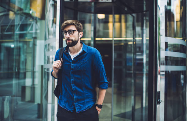 istock Employee in eyeglasses exiting from business center 1450675291