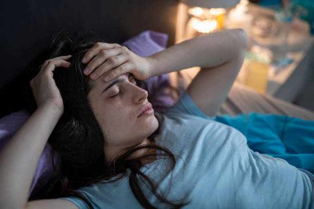 istock Sick woman laying in bed. 1450677135