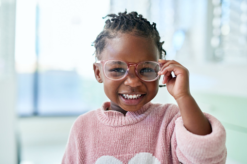Young girl, glasses and vision with frame and lens, eyewear shopping with eye care and optometry with kid in portrait. Eye health, prescription for eyes with child at optometrist office or store.