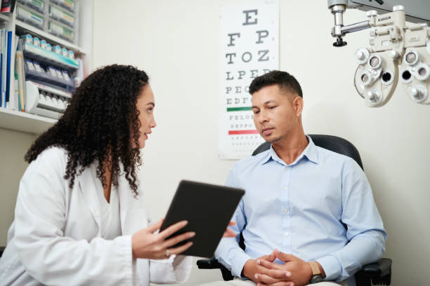 Optometry, tablet and optician with man for results, communication and consulting about vision. Healthcare, medical and ophthalmologist talking to a patient about eye care after an exam with tech Optometry, tablet and optician with man for results, communication and consulting about vision. Healthcare, medical and ophthalmologist talking to a patient about eye care after an exam with tech eye care professional stock pictures, royalty-free photos & images