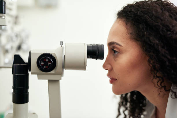 Optometry, eye exam and optometrist working at a clinic with an optical autorefractor machine. Eyesight, medical and professional woman optician doing a vision test for eye care in an optic store.