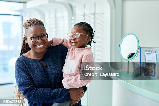 istock Glasses, mother and child portrait, happy for eyecare and eyes wellness or vision. Black woman, kid and happiness or smile for eyeglasses, sight healthcare and lens frame in optometrist office 1450677533