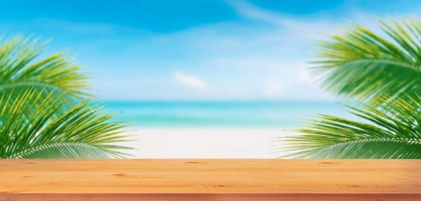 istock Top wood table and palm tree and tropical beach background.Empty ready for your product display montage. 1450679567