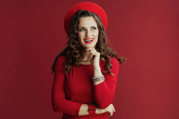 istock smiling modern female in red dress and beret 1450680452