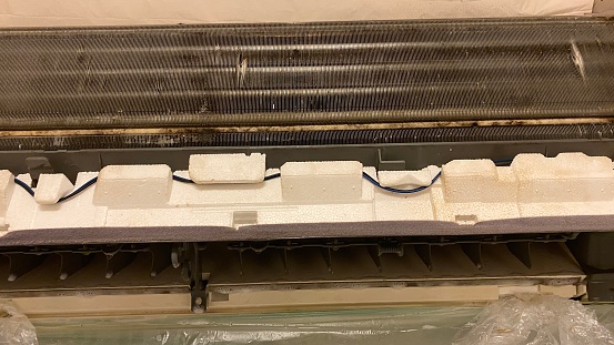 Inside a dirty air conditioner before cleaning at home