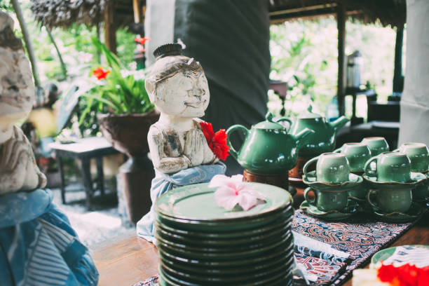 istock Table setting with exotic figures and crockery at break area 1450680832
