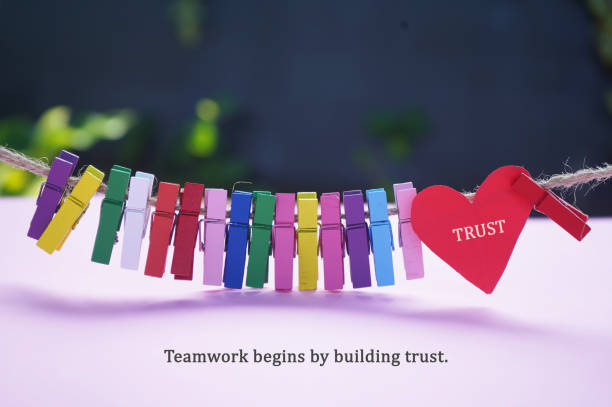 istock Trust and Teamwork concept with colorful wooden clips on rope. 1450680916