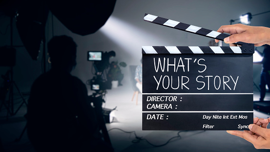 What's your story, Handwriting on film slate or clapperboard .film crew working in the studio.