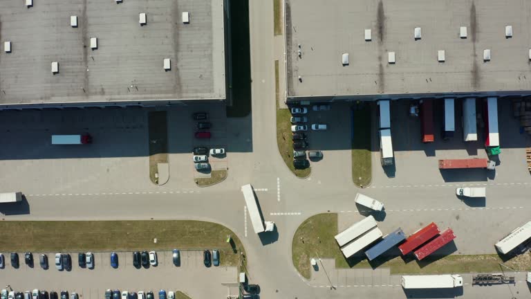 Large logistics park with a warehouse, a loading hub with many trucks