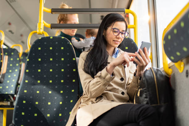 istock Woman using mobile phone at the public transport 1450697310