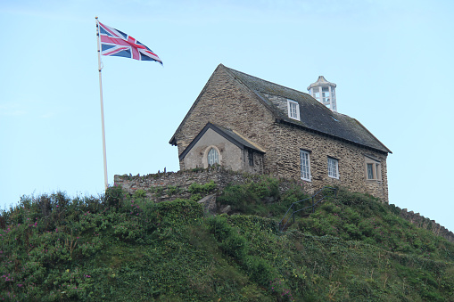 A Small Religious Chapel on the Top of a Coastal Cliff.