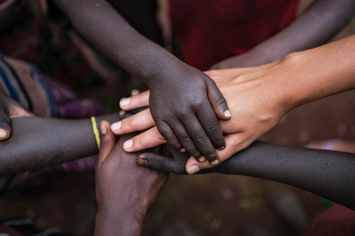 Multiracial human hands in one of African villages, Ethiopia, East Africa