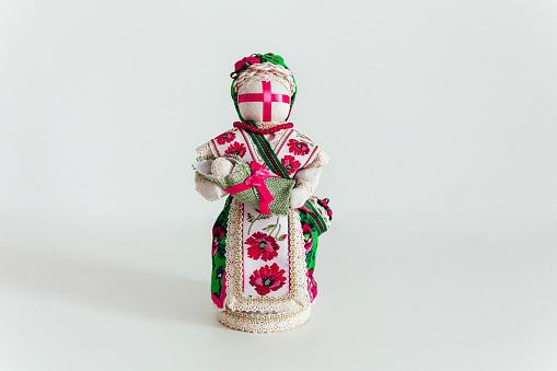 Ukrainian traditional hand made doll, nesting doll, Motanka doll in national costume. Isolated on white.