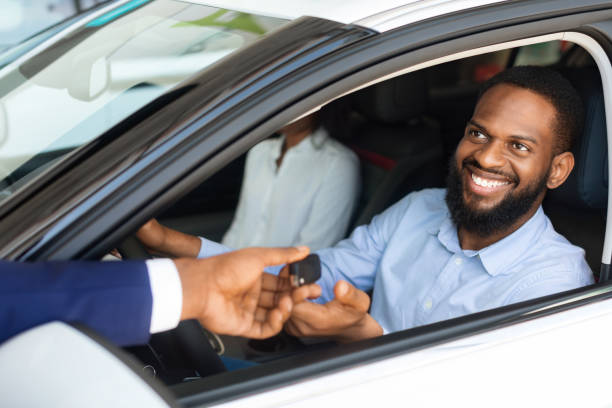 istock Happy Black Spouses Taking Car Key From Rental Service Manager 1450708511