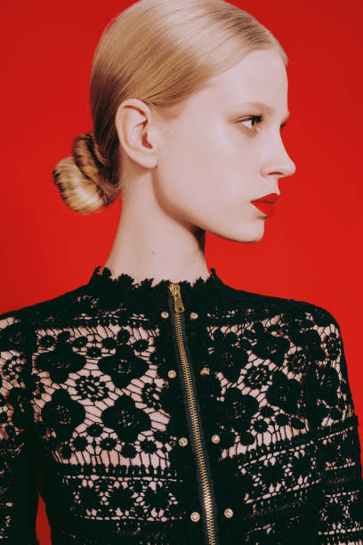 istock Blonde woman with red lips on a red background. 1450710989