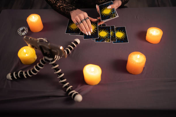 istock Fortune teller reading fortune lines on screen smartphone, online fortune telling application. Palmistry Psychic readings and clairvoyance concept with Tarot cards 1450712318