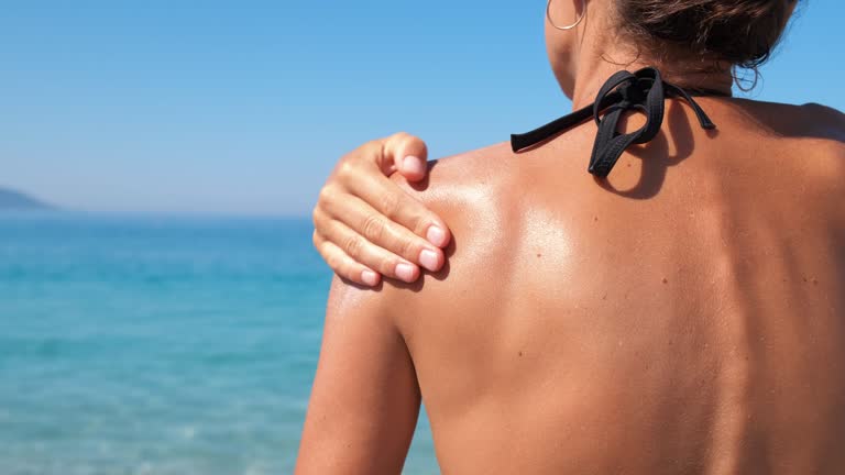 Female with protective moisturizer on shore.