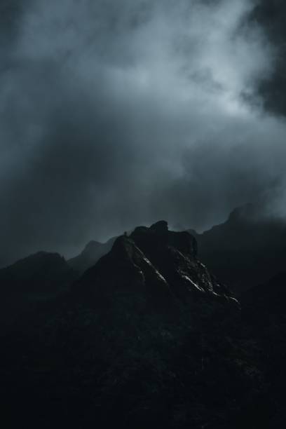 istock Vertical dramatic shot of a rock against the stormy clouds 1450715616