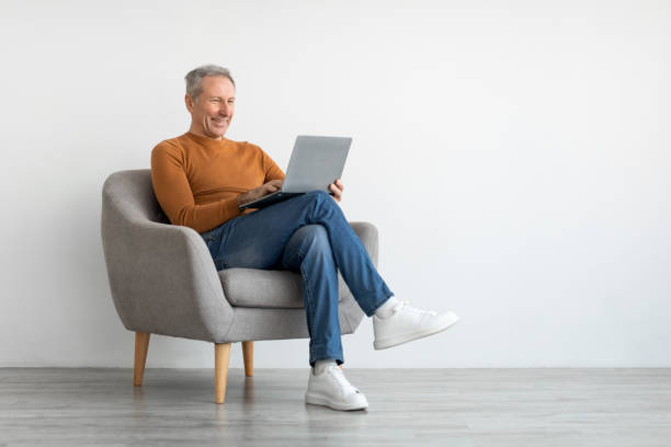 istock Confident smiling mature man using laptop at home 1450718566